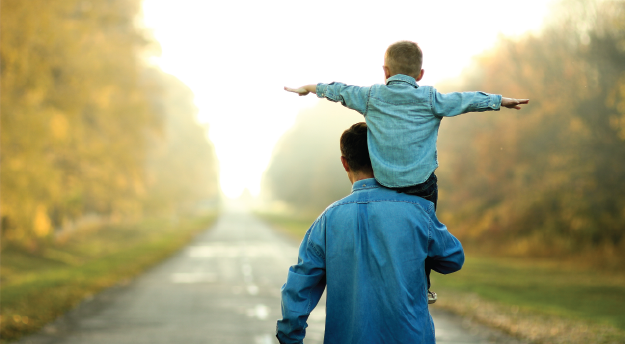 Father holding boy on his shoulder