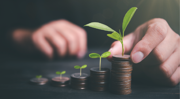 Plants sprouting out of coins