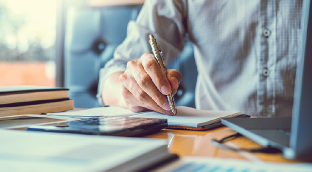 Man writing on a notepad