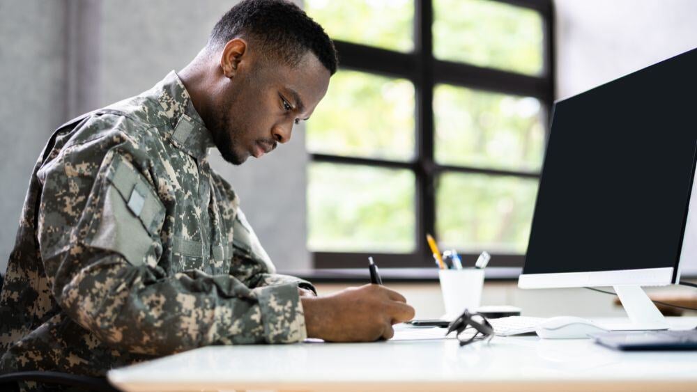 Soldier writing at desk